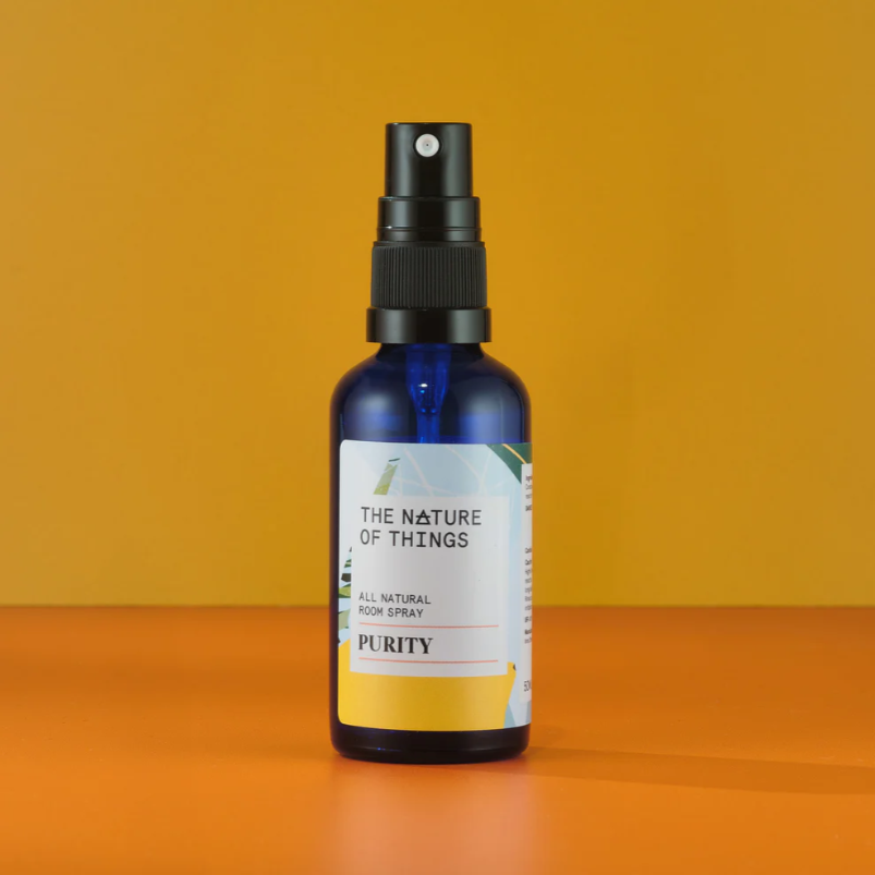 Bottle of 'The Nature of Things' Purity room spray on an orange background