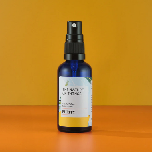 Bottle of 'The Nature of Things' Purity room spray on an orange background